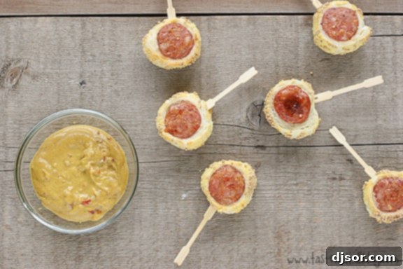 Pigs in a Blanket Bites served on a platter with Creole mustard.