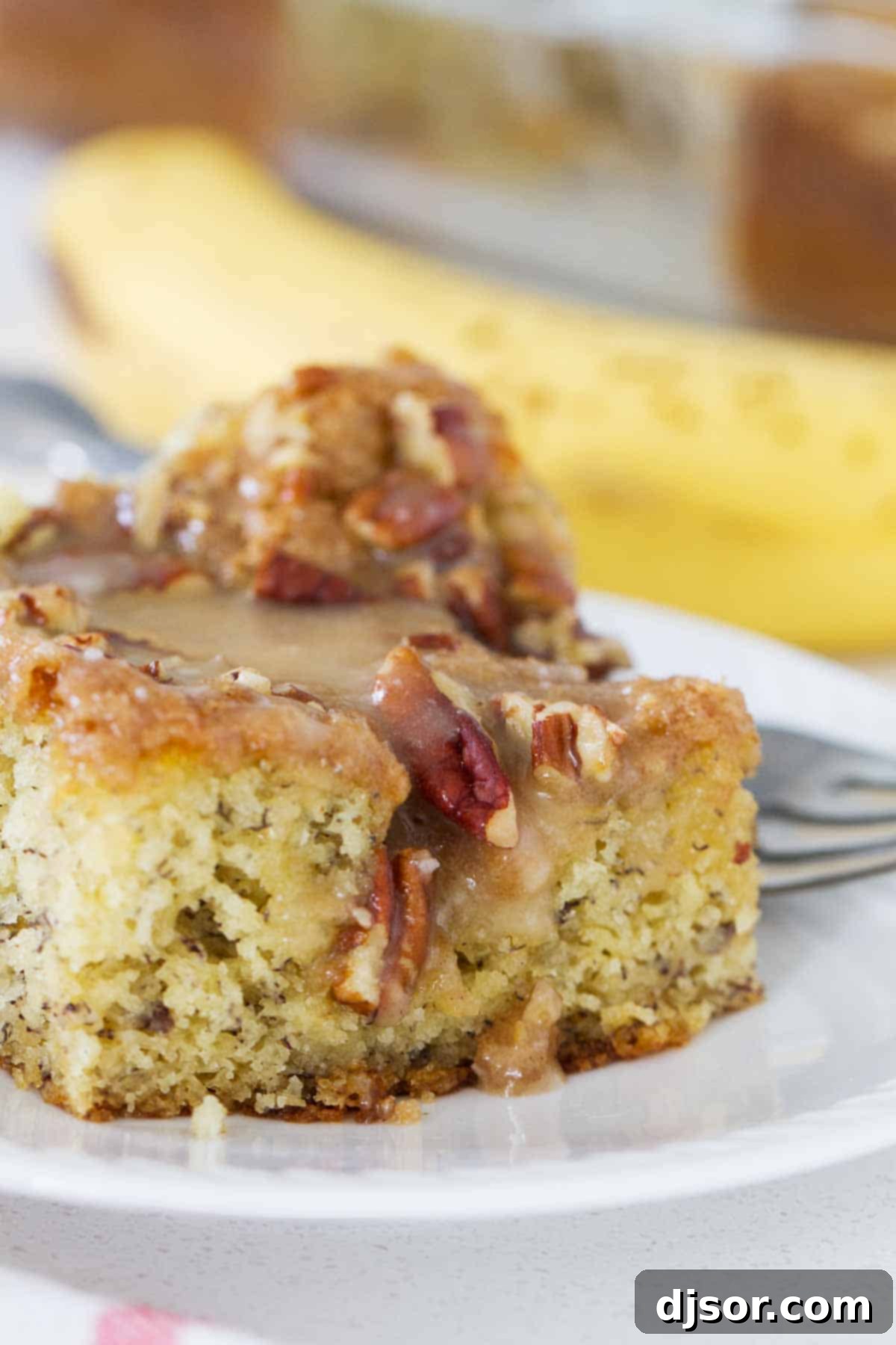 slice of banana coffee cake with honey glaze and pecans