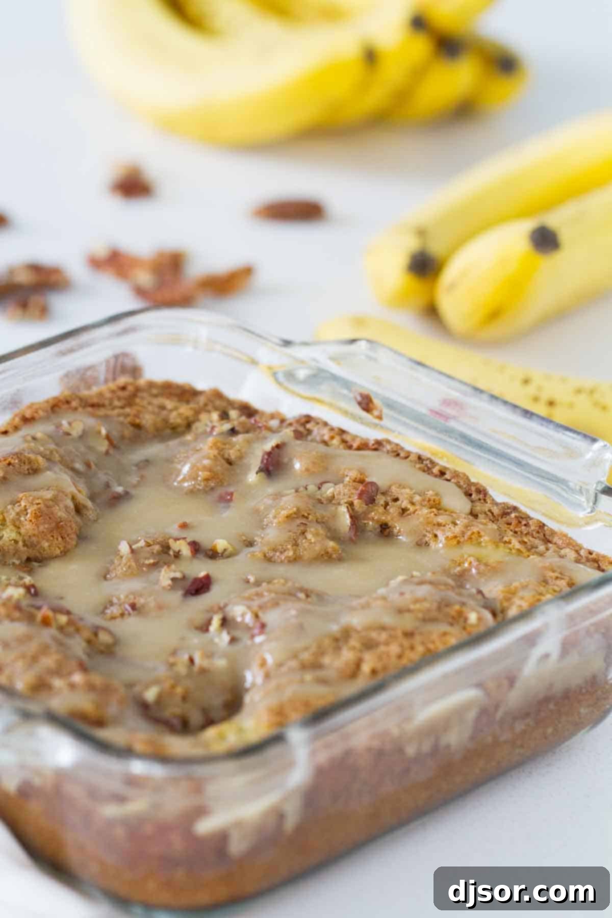 banana coffee cake with honey glaze in a baking dish