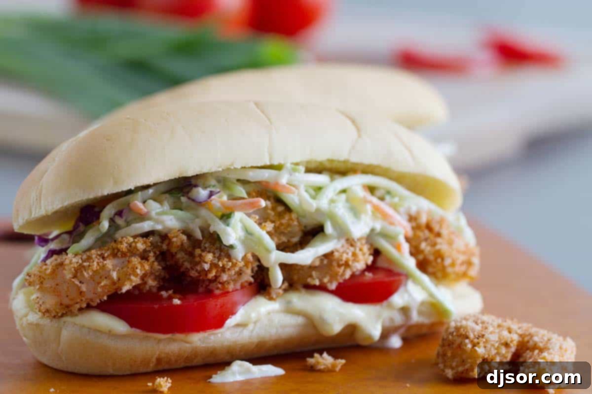 Shrimp Po Boy Sandwich with pineapple slaw and tomatoes, showcasing the vibrant colors and textures.