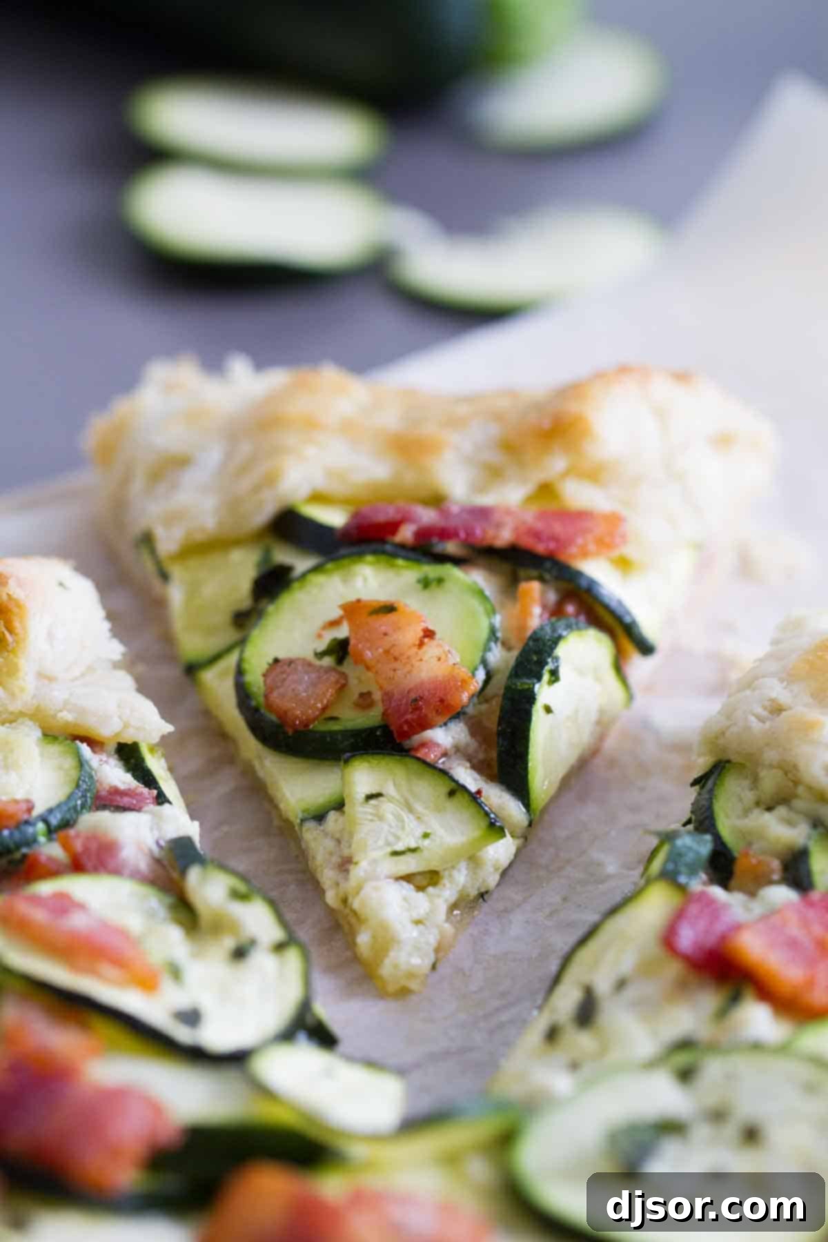 Zucchini Tart with Ricotta and Bacon - Slice View A perfectly baked slice of zucchini tart with crispy bacon on top, revealing the creamy ricotta filling.