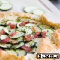 Golden Zucchini Tart with Creamy Ricotta and Bacon 2 Full zucchini tart with ricotta and bacon on a cutting board