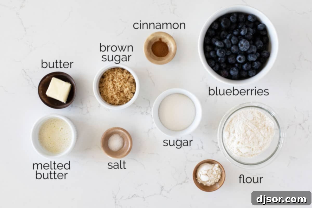 Fresh ingredients laid out on a wooden surface, ready for making blueberry crisp.