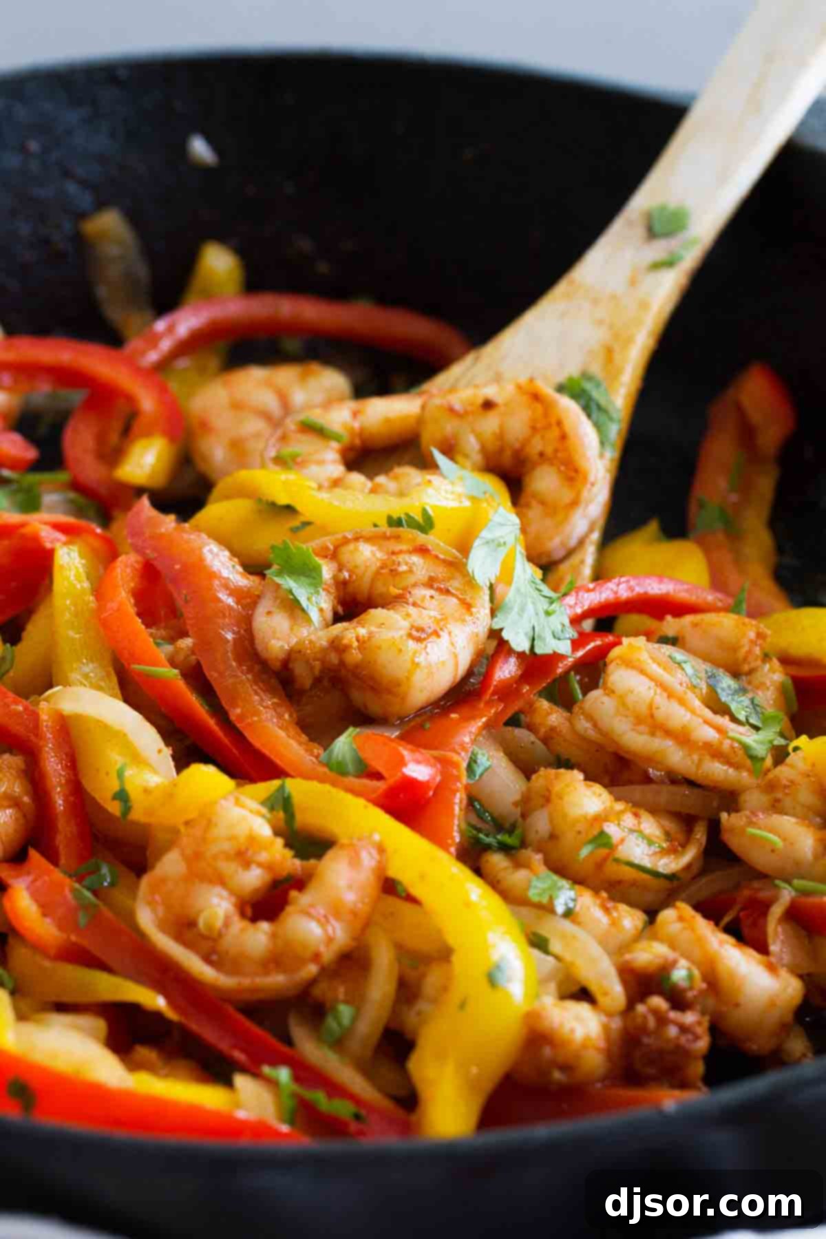 Close-up of vibrant Shrimp Fajitas with perfectly cooked bell peppers and onions, showcasing the rich colors and textures.