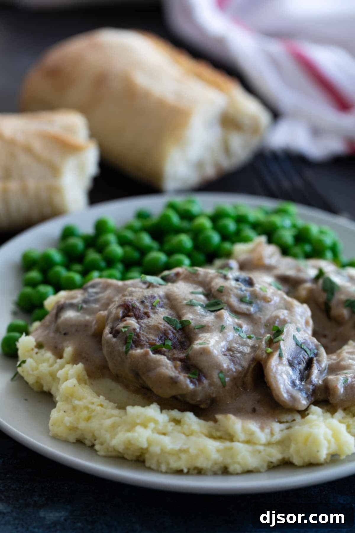 An inexpensive, filling and comforting meal that is family friendly and full of flavor, this Salisbury Steak Recipe is a childhood throwback that you’ll want to make over and over again. Salisbury Steak with Gravy served on top of mashed potatoes, a complete comfort meal.