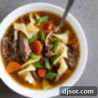 Hearty Slow Cooker Beef Noodle Soup 2 Slow Cooker Beef Noodle Soup with vegetables.