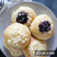Homemade Kolaches 2 cream cheese and blueberry filled kolaches on a plate