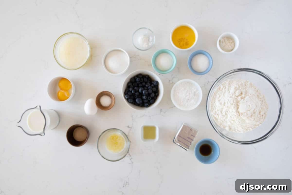 Key Ingredients for Homemade Kolaches Ingredients laid out for making Kolaches, including flour, butter, eggs, milk, blueberries, and cream cheese.