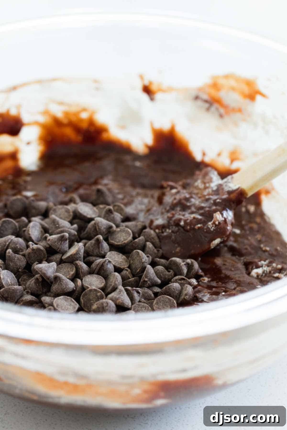 A bowl of rich, velvety chocolate brownie batter being mixed, ready for preparation in the pressure cooker.