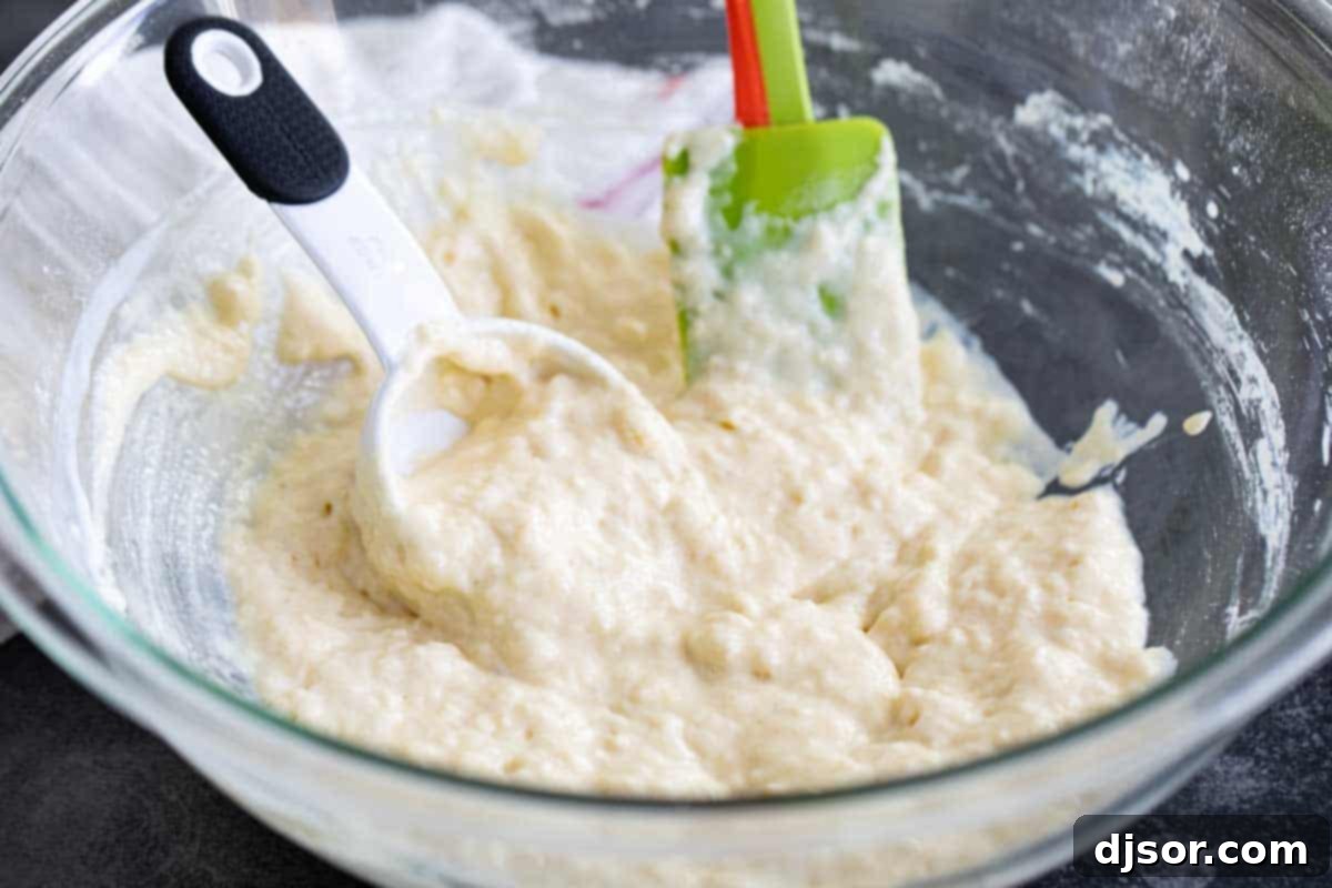 Mixing the Batter for Fluffy Homemade Pancakes Smooth, well-mixed pancake batter in a large bowl, ready for cooking