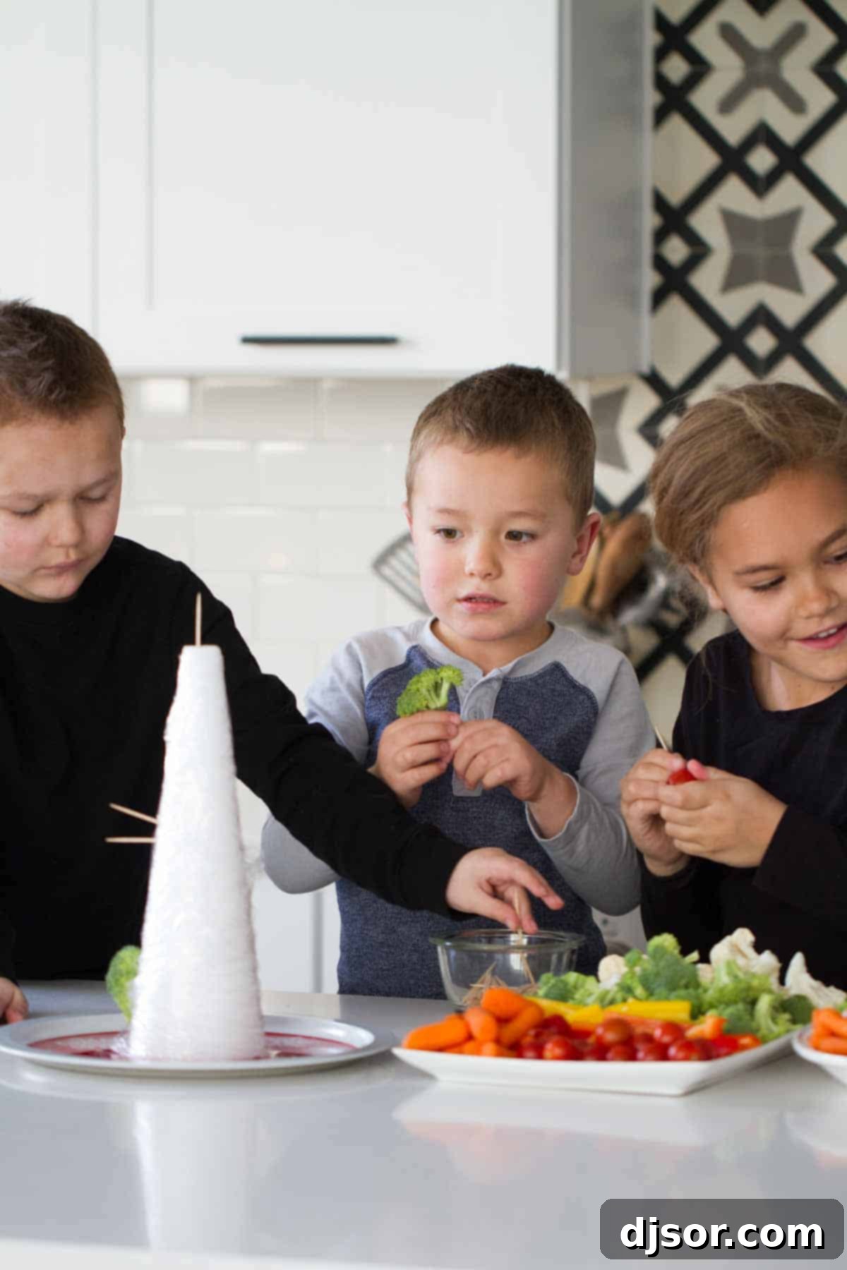 Festive Veggie Trees with Savory Bacon Chive Ranch Dip 3 Kids joyfully putting together a Veggie Christmas Tree, highlighting a fun and interactive family activity.