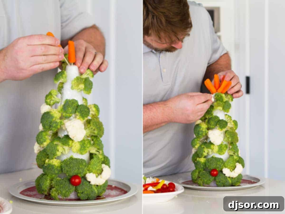 Festive Veggie Trees with Savory Bacon Chive Ranch Dip 5 A man carefully assembling a Vegetable Christmas tree, demonstrating the step-by-step process.