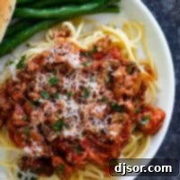 My Signature Spaghetti Sauce 5 Close-up of freshly cooked spaghetti topped generously with homemade meat spaghetti sauce and garnished with parsley.