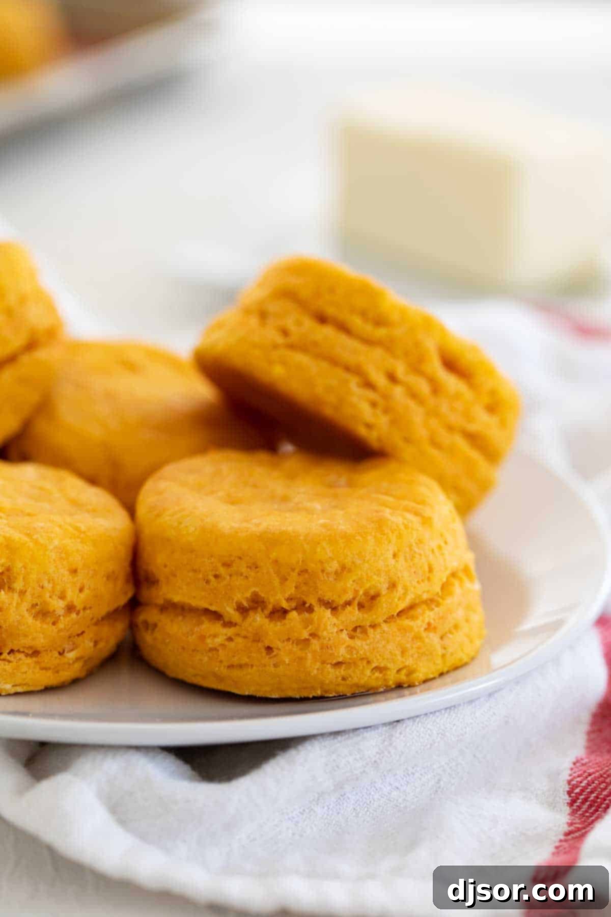 Extra tender with a soft texture and slightly sweet flavor, these Sweet Potato Biscuits are the perfect southern side dish. These are perfect for breakfast, dinner, or for your holiday table. close up of sweet potato biscuits