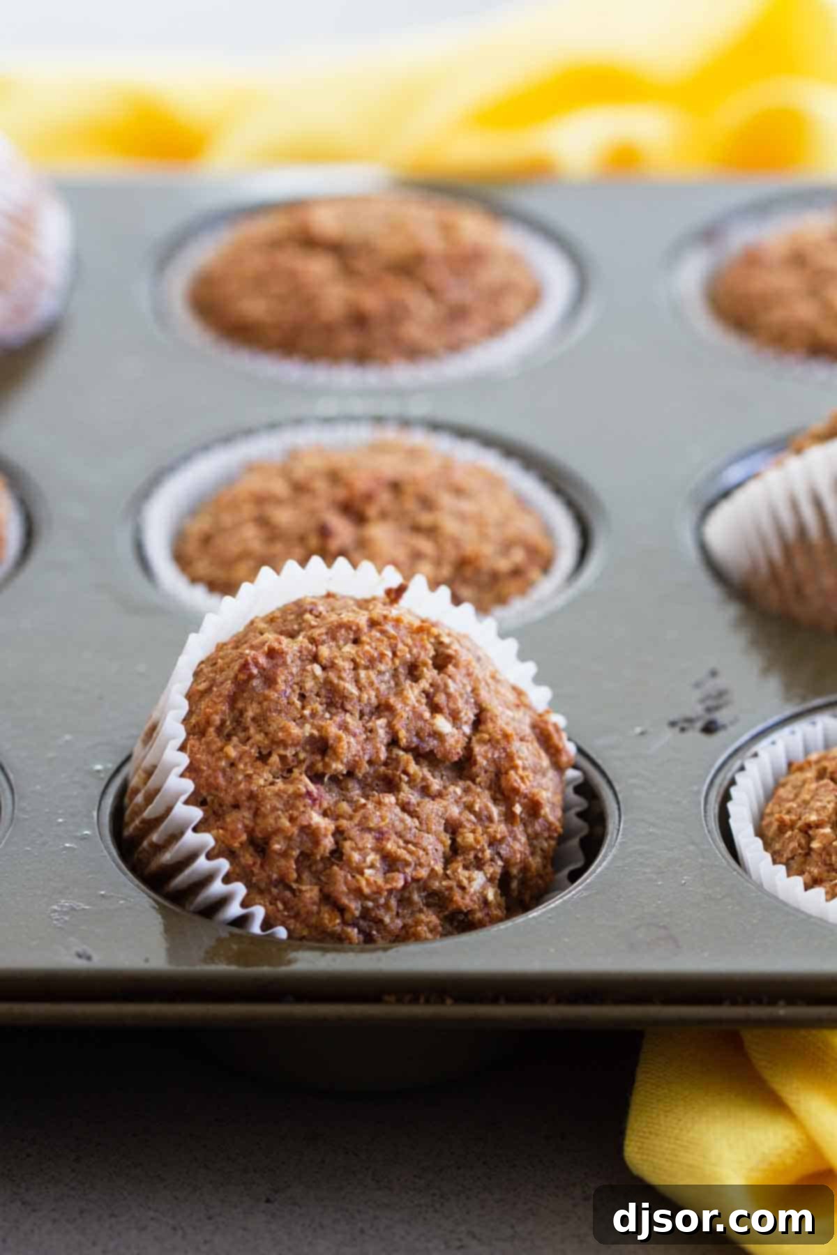 Close-up of golden brown Whole Wheat Bran Muffins, showcasing their healthy, hearty texture and delicious appeal.