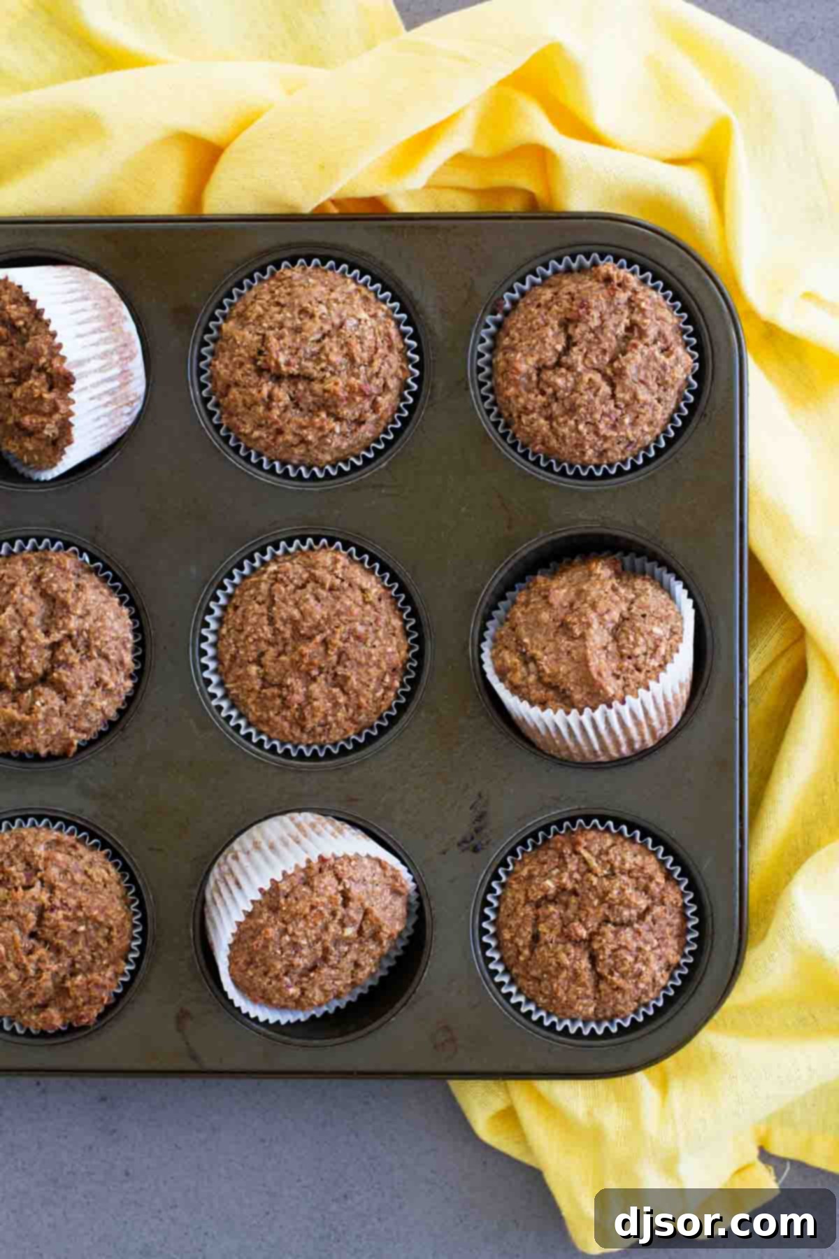 Freshly baked Whole Wheat Bran Muffins cooling in a muffin pan, ready to be enjoyed as a healthy breakfast.