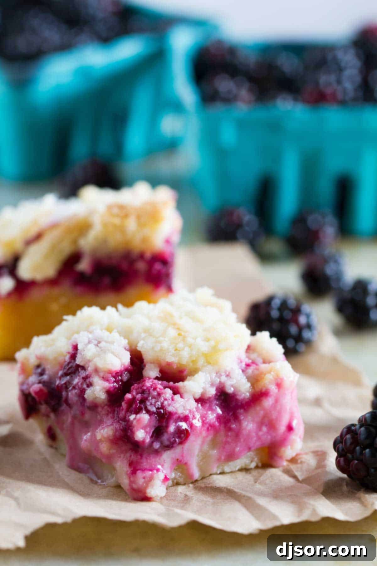 A single Blackberry Pie Bar with a shortbread base, creamy blackberry filling, and streusel topping, placed on a piece of brown paper, ready to be enjoyed.