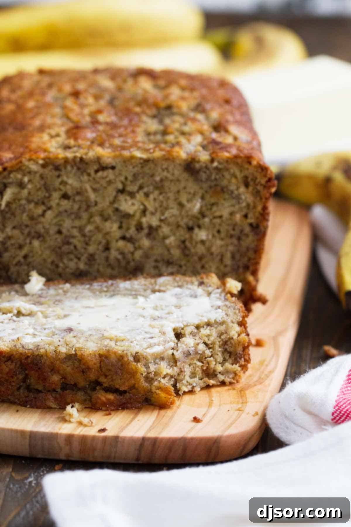 Slice of Banana Oat Bread with butter.