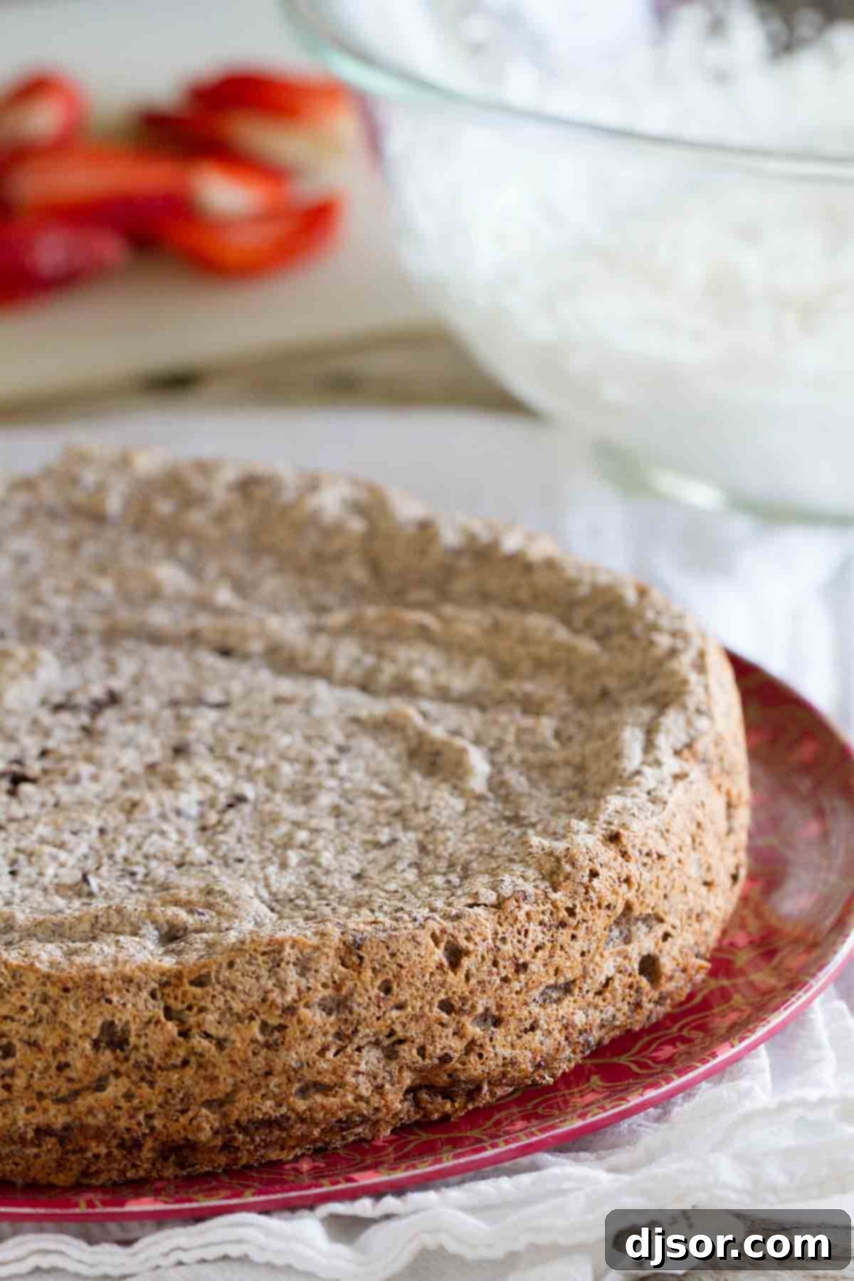 Elegant Italian Chocolate Almond Flourless Cake on a plate A single slice of Italian Chocolate Almond Flourless Cake artfully presented on a white plate, highlighting its rich, dark interior and inviting texture.