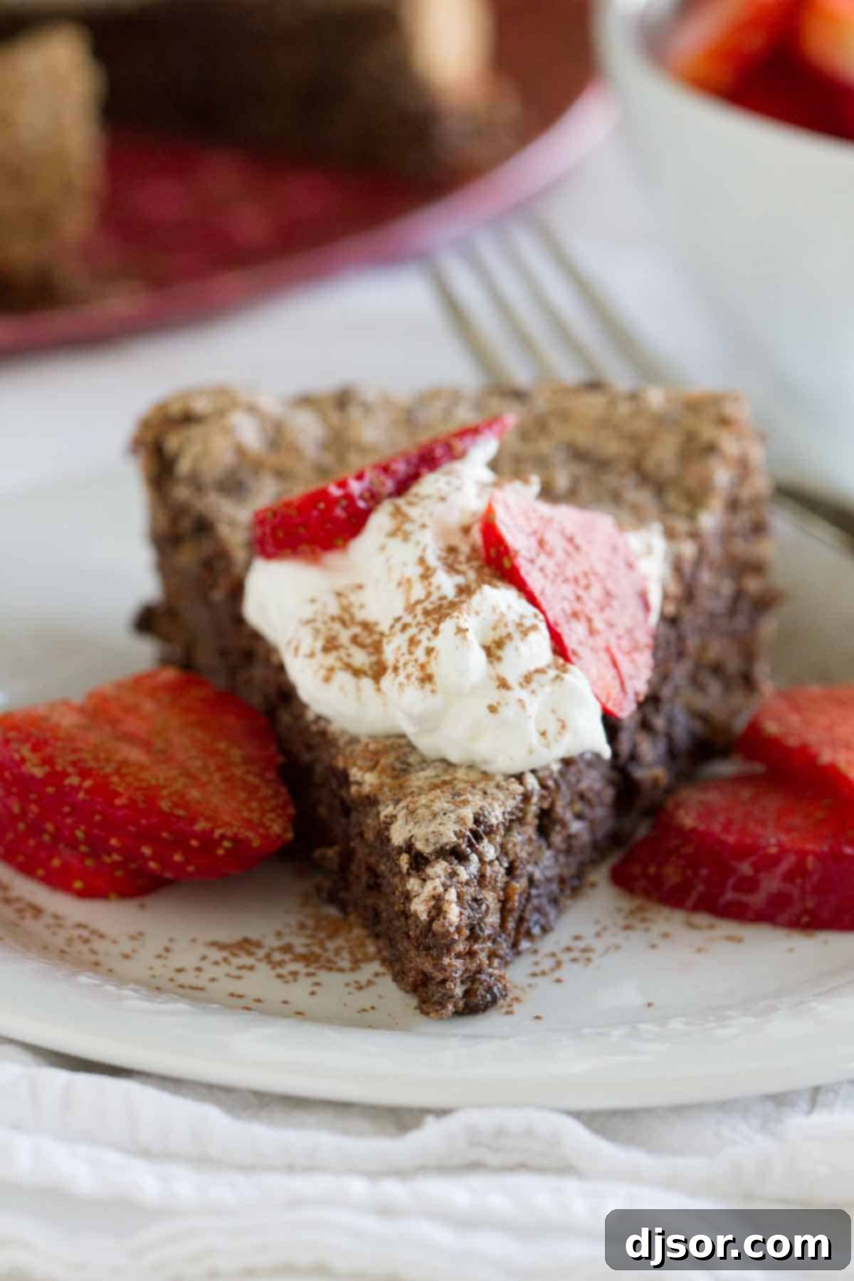Decadent slice of chocolate flourless cake with berries Close-up of a delightful slice of chocolate flourless cake, garnished with a medley of fresh berries, emphasizing its rich texture.