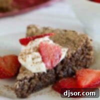 Decadent Italian Flourless Chocolate Almond Delight 2 A delicious slice of Italian Chocolate Almond Flourless Cake, beautifully topped with fresh whipped cream and sweet strawberries, ready to serve.