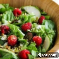 Vibrant Raspberry Spinach Salad 2 Raspberry Spinach Salad with Raspberry Vinaigrette in a wooden bowl.
