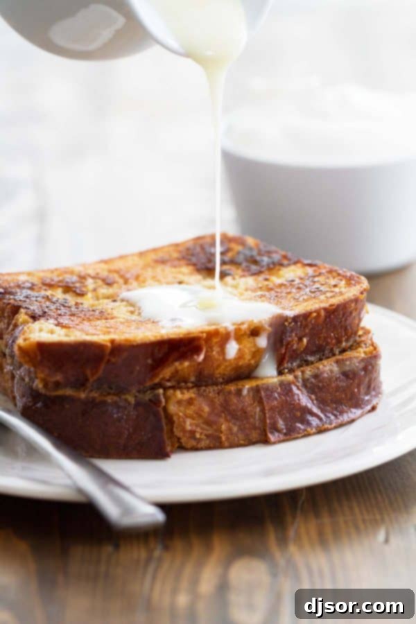 Indulge in the decadent sweetness of French Toast drizzled with sweetened condensed milk – a true breakfast delight. Sweet French Toast generously topped with luscious sweetened condensed milk, showcasing its rich, golden-brown crust