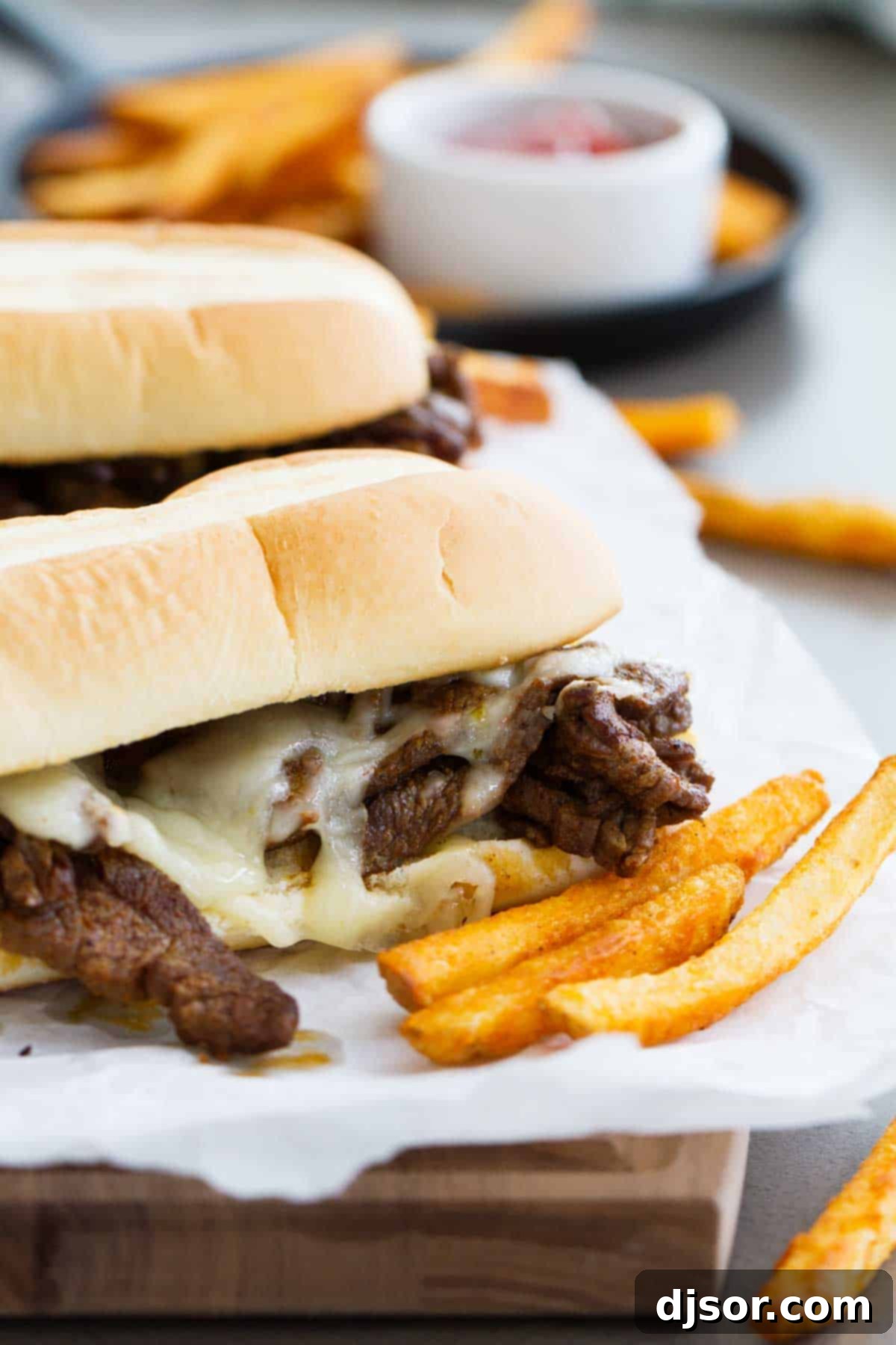 Spicy Cajun Cheesesteak Sandwiches with french fries on the side, showcasing a delicious and satisfying lunch.