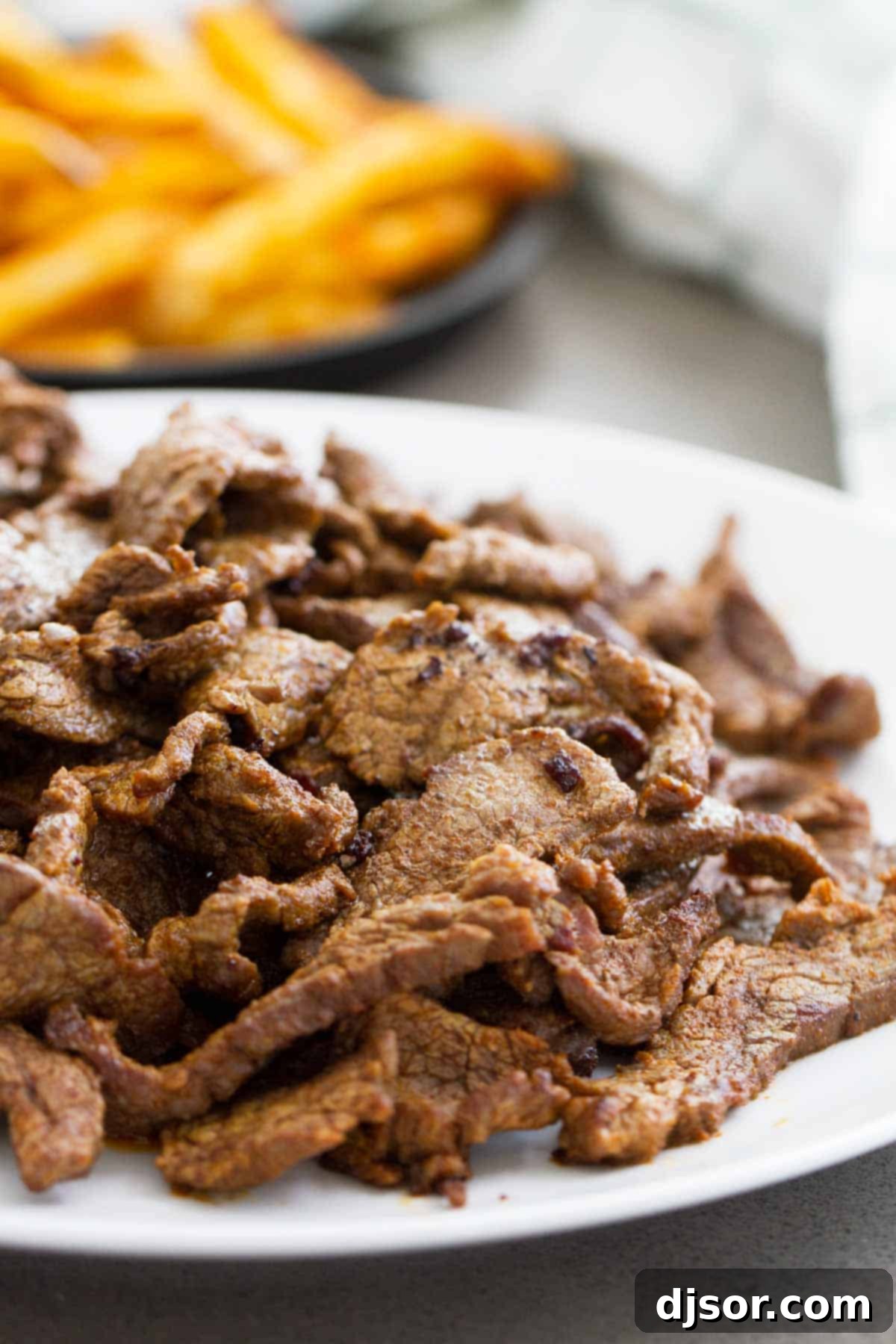 Perfectly cooked flank steak, thinly sliced and ready to be assembled into delicious Spicy Cajun Cheesesteak Sandwiches.