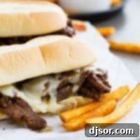 Spicy Cajun Cheesesteak Sandwiches with french fries on the side