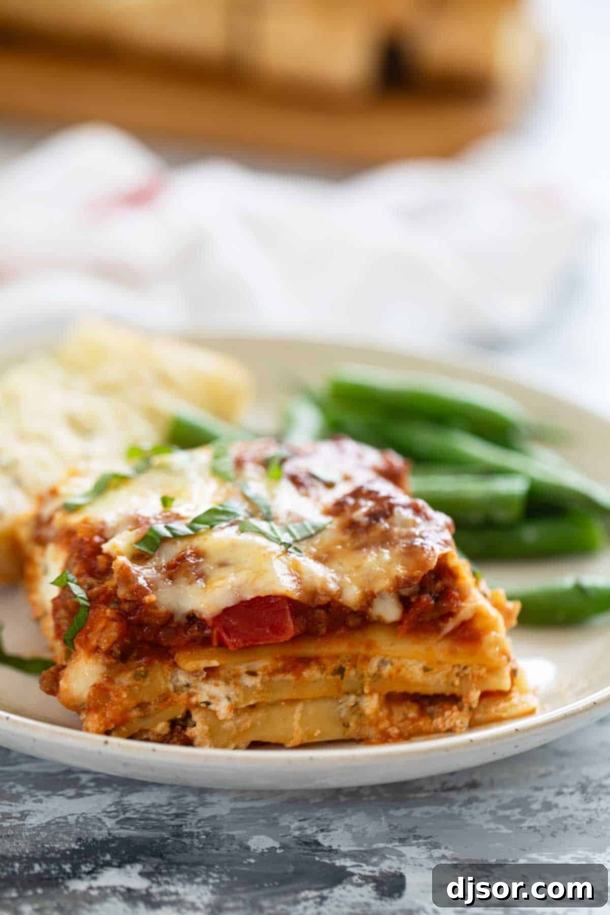 Slice of lasagna with beef and pork.