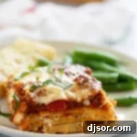Slice of lasagna with beef and pork.
