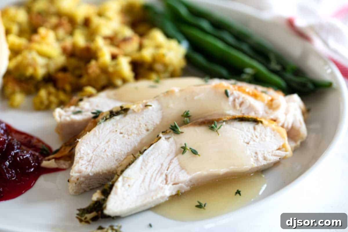 Roast Turkey Breast with Herbed Butter: A Moist and Flavorful Small Family Dinner Slices of perfectly roasted turkey breast with golden skin, served with rich gravy and classic holiday side dishes like mashed potatoes and green beans on a festive plate.