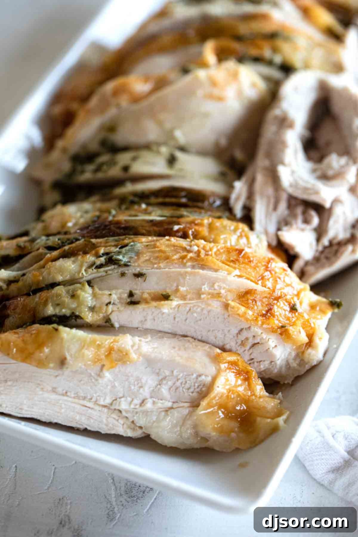 Perfectly Sliced Roast Turkey Breast: Juicy, Tender, and Ready to Serve Beautifully sliced roast turkey breast arranged on a serving plate, showing off its tender, juicy meat and crispy, golden-brown skin, ready to be enjoyed.