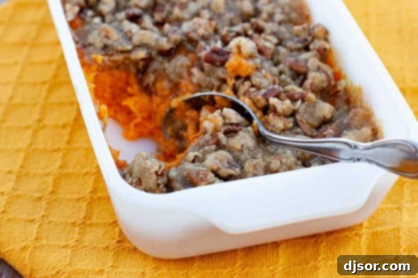 Crafting Your Perfect Thanksgiving 5 A textured close-up of a unique sweet potato dish, showing mashed sweet potatoes blended with banana and drizzled with honey, in a rustic bowl.