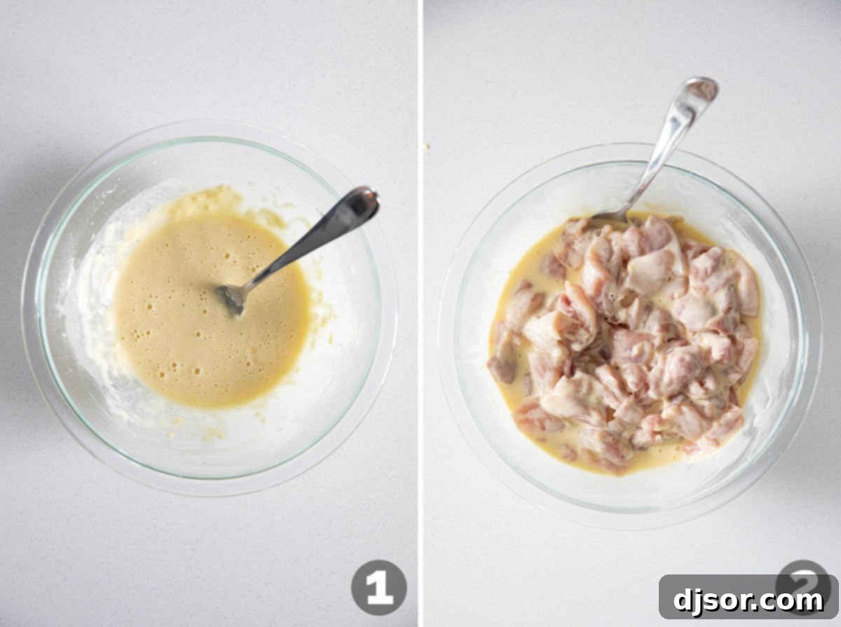 Bite-sized chicken pieces are coated in a light batter, preparing them for frying to create crispy homemade orange chicken.