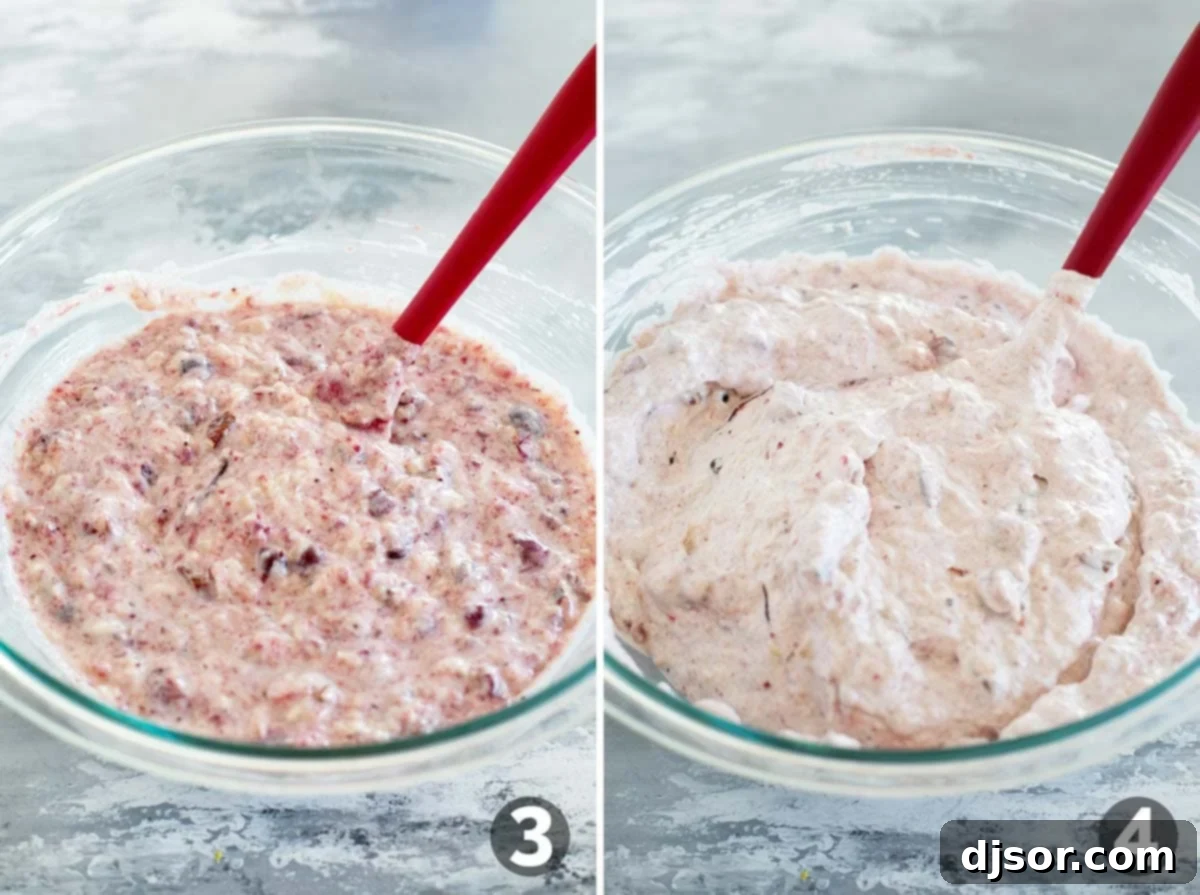 Ruby Red Cranberry Ambrosia 5 The process of making Cranberry Salad continues, showing the mixed fruit and nut base being combined thoroughly, followed by the gentle folding in of thawed cool whip to create the light and fluffy texture.