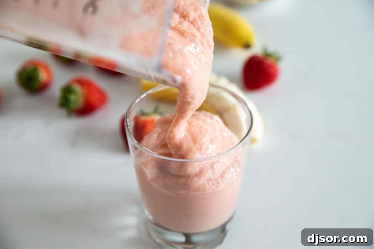 pouring tropical smoothie into a cup