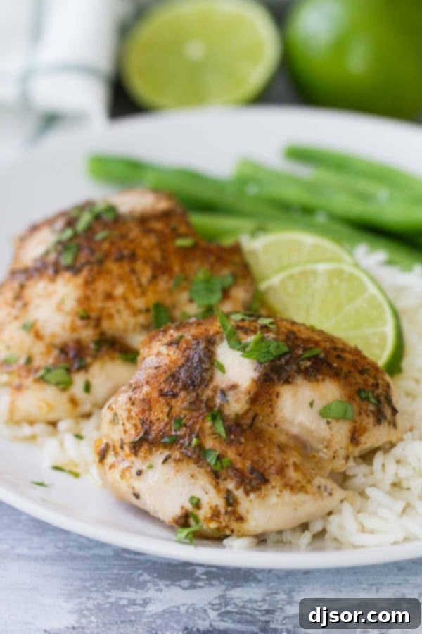 Easy Lime Baked Chicken Thighs on a baking dish, garnished with lime slices.