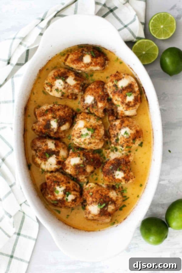 Close-up of baked chicken thighs glistening with lime juice and spices.
