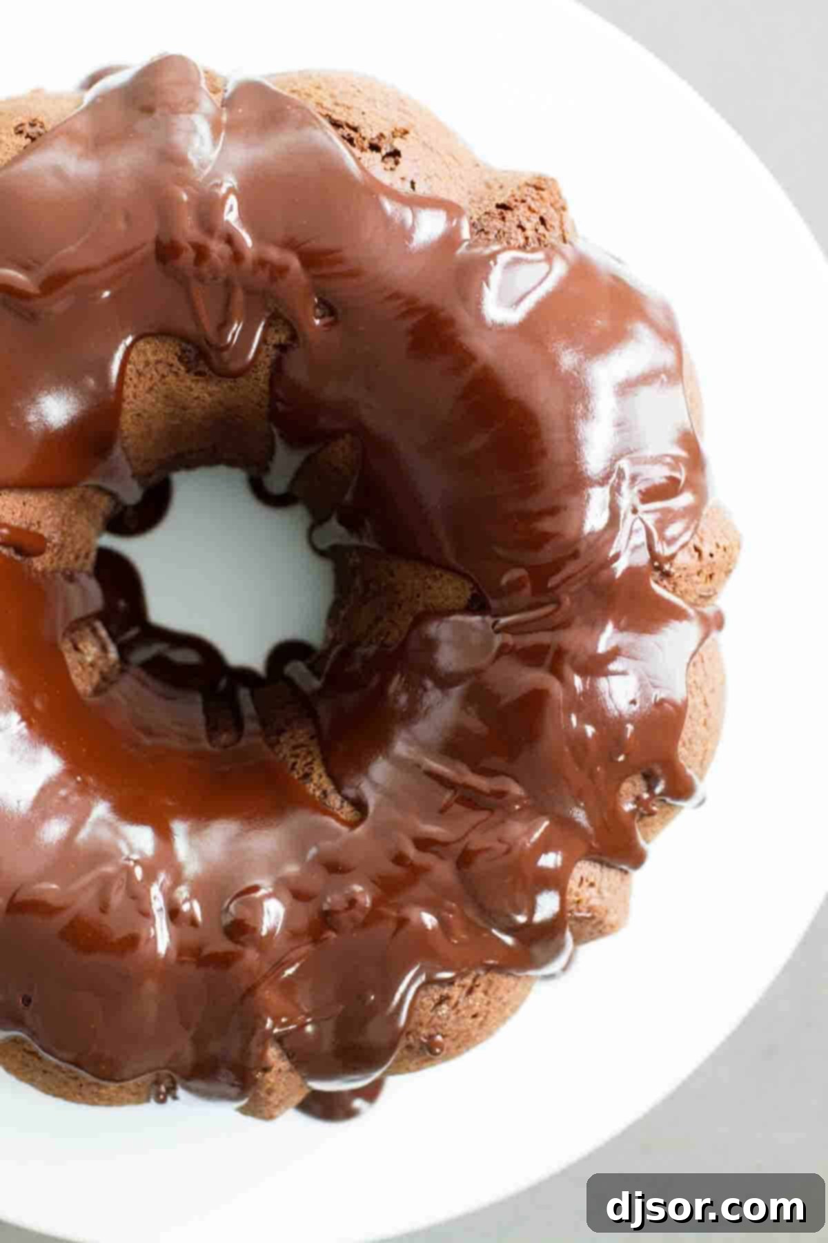 Decadent Chocolate Glaze on Bundt Cake Close-up view of the shiny, satiny chocolate glaze elegantly coating a rich chocolate bundt cake.