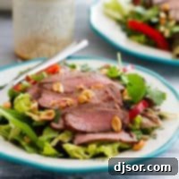 Spicy Thai Beef Salad 2 Plate with Thai Beef Salad topped with peanuts.