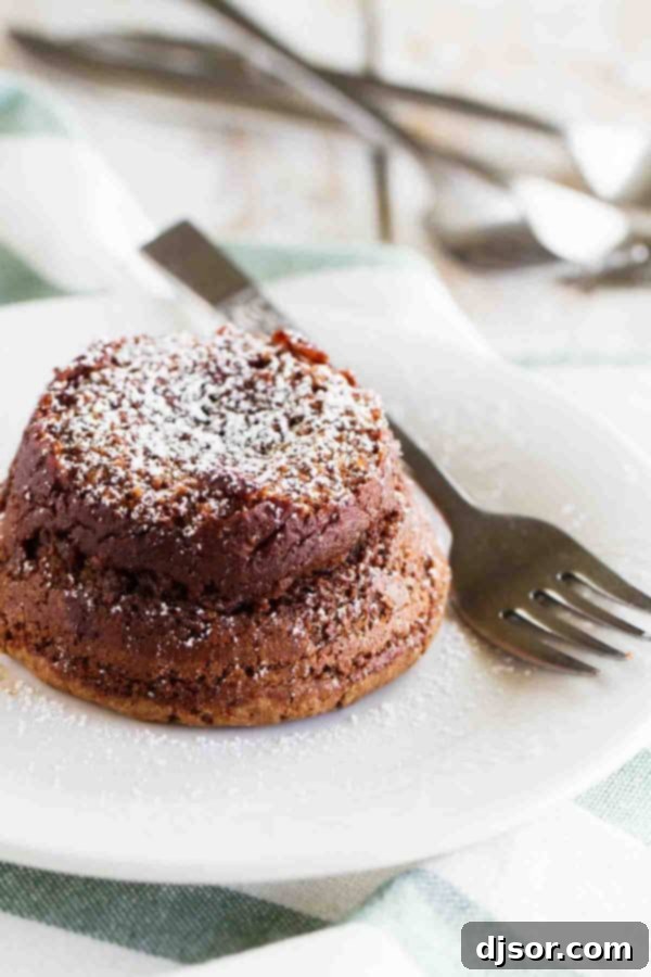 Chocolate Molten Lava Cake served with whipped cream and chocolate syrup, showcasing its gooey center.