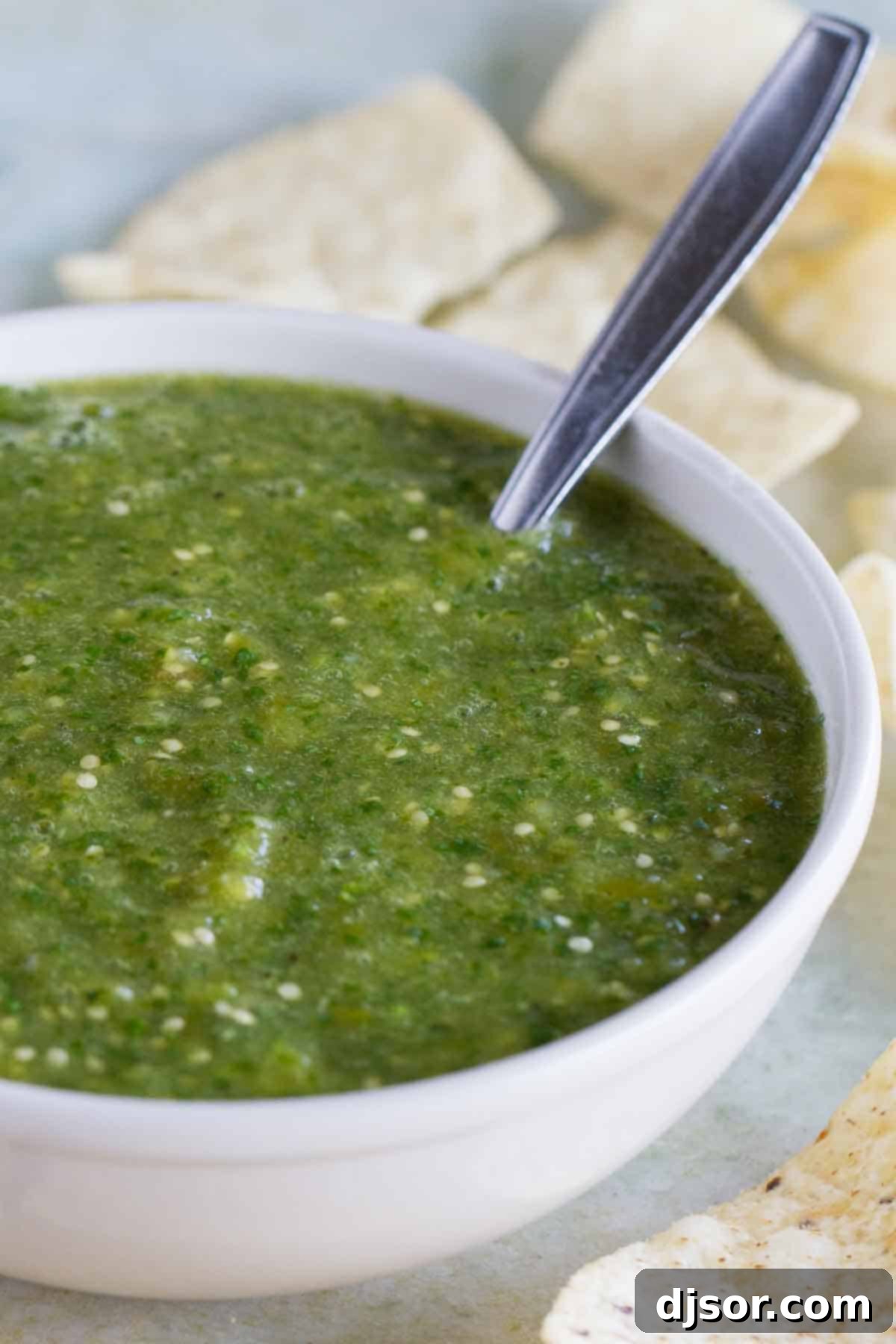 Bowl of Fresh Tomatillo Salsa Verde A beautifully presented bowl of vibrant green Tomatillo Salsa Verde, garnished with fresh cilantro, ready to be served.