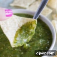 Vibrant Tomatillo Salsa Verde 2 Tomatillo Salsa Verde on a tortilla chip