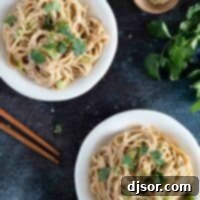 Two plates of Thai Peanut Noodles topped with fresh cilantro, a delicious and vibrant meal.