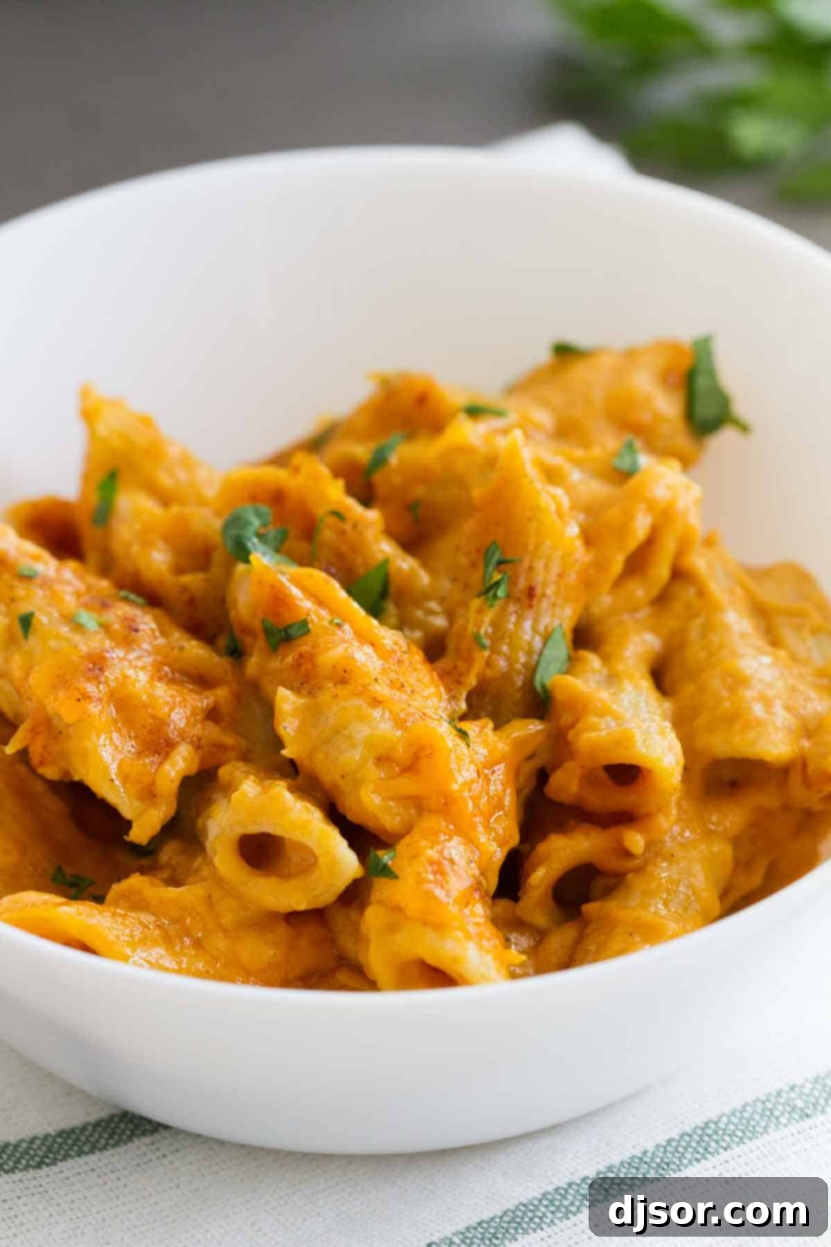 Bowl filled with pumpkin cheddar mac and cheese.