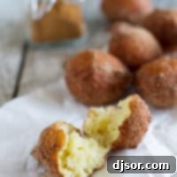 Ricotta Doughnut broken in half, showcasing its fluffy interior.