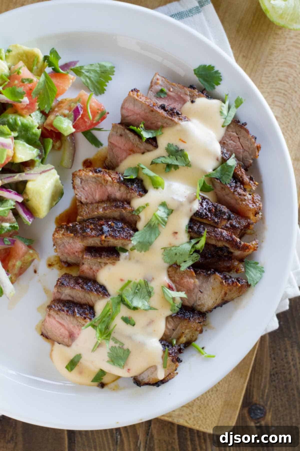 Zesty Mexican Steaks with Creamy Chile Queso 3 Sliced steak with Mexican spices, topped generously with creamy Chile con queso and fresh cilantro.