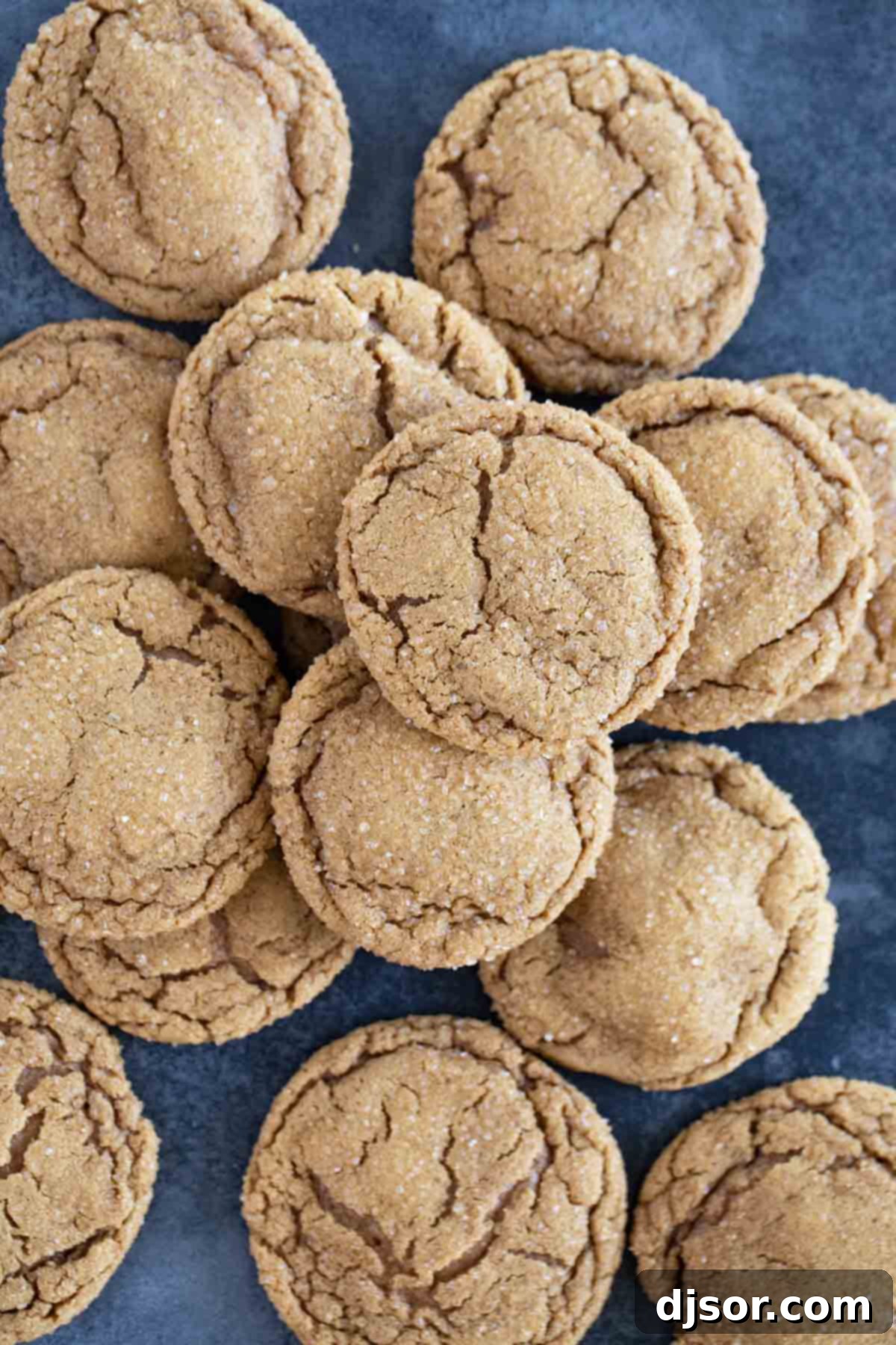 Pile of soft ginger cookies on a blue background.